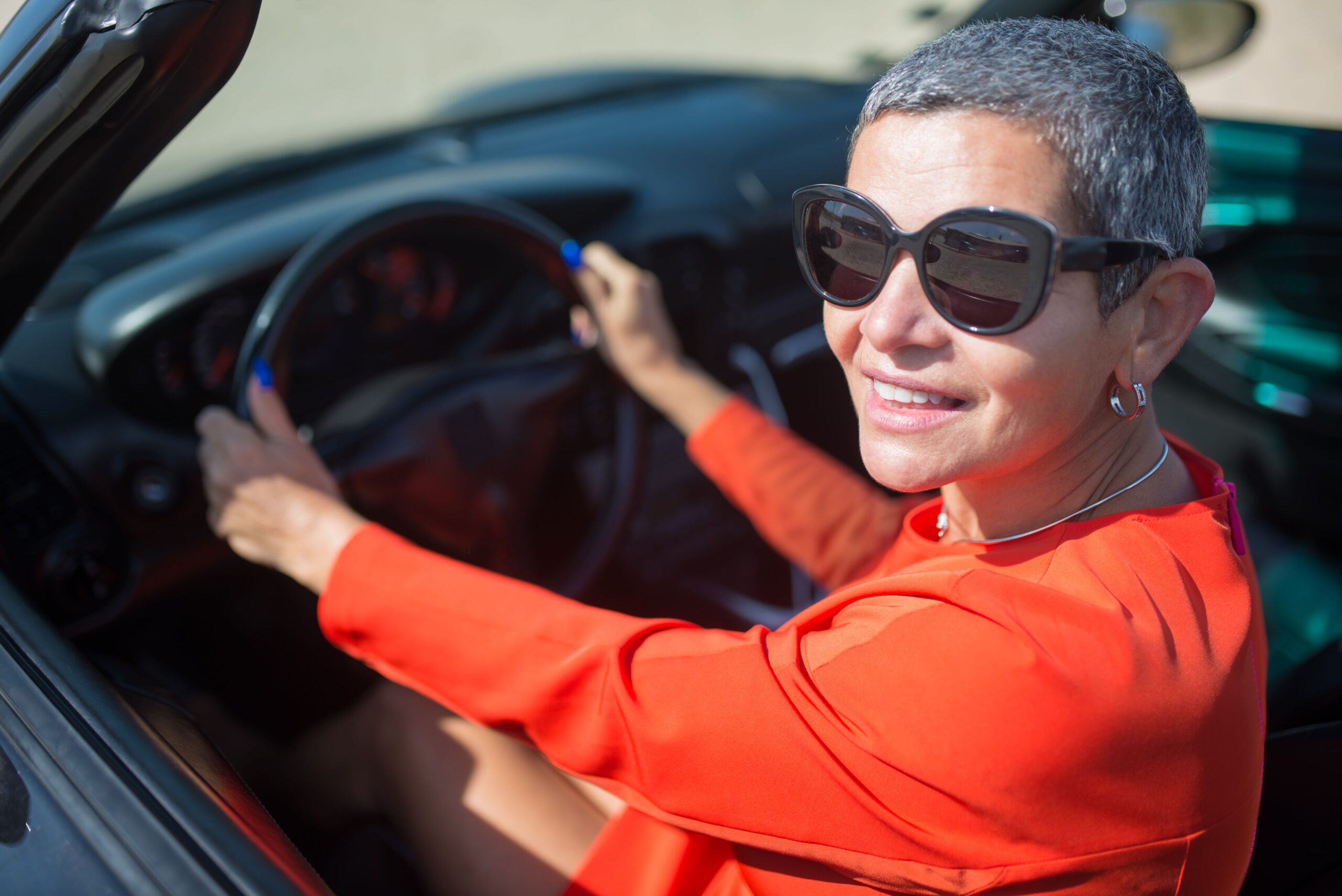 Happy customer driving her well-maintained car